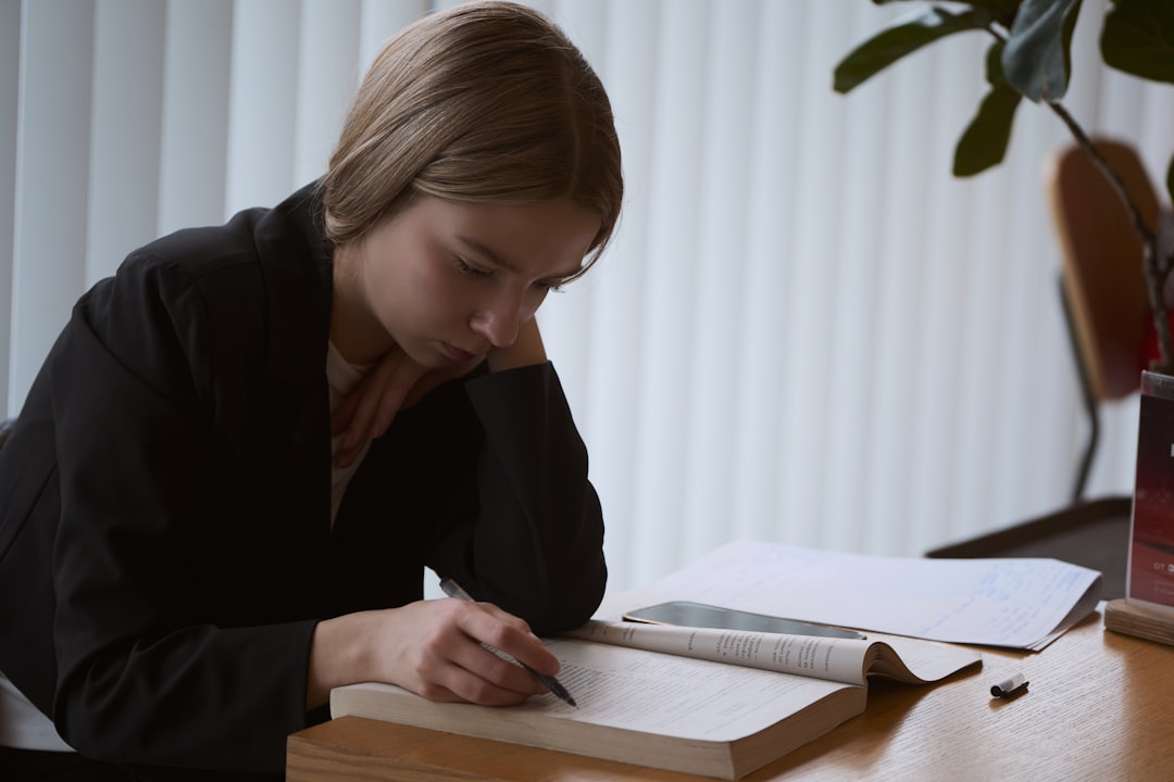 Nursing student reviewing notes at a desk during ATI remediation after a Level 1 score