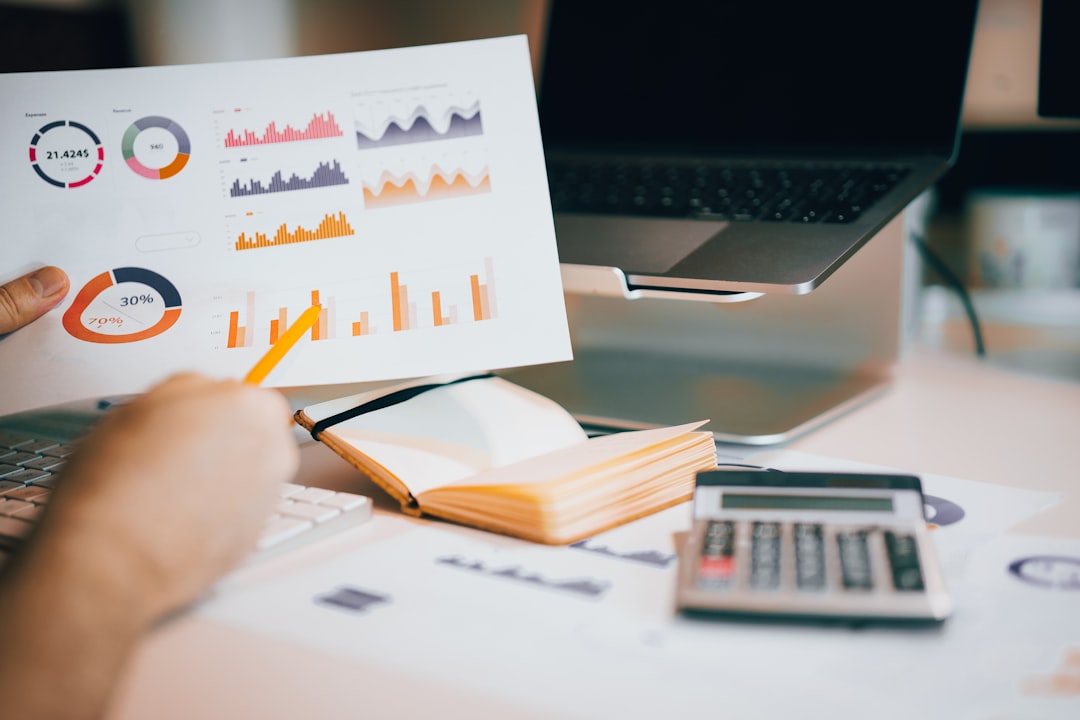 Charts and wage data on a desk with a calculator, illustrating what BLS pay and demand figures can and cannot tell you