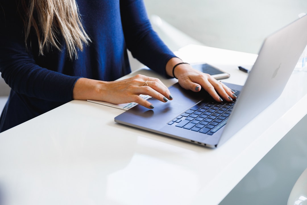 Nurse completing an online licensure application on a laptop