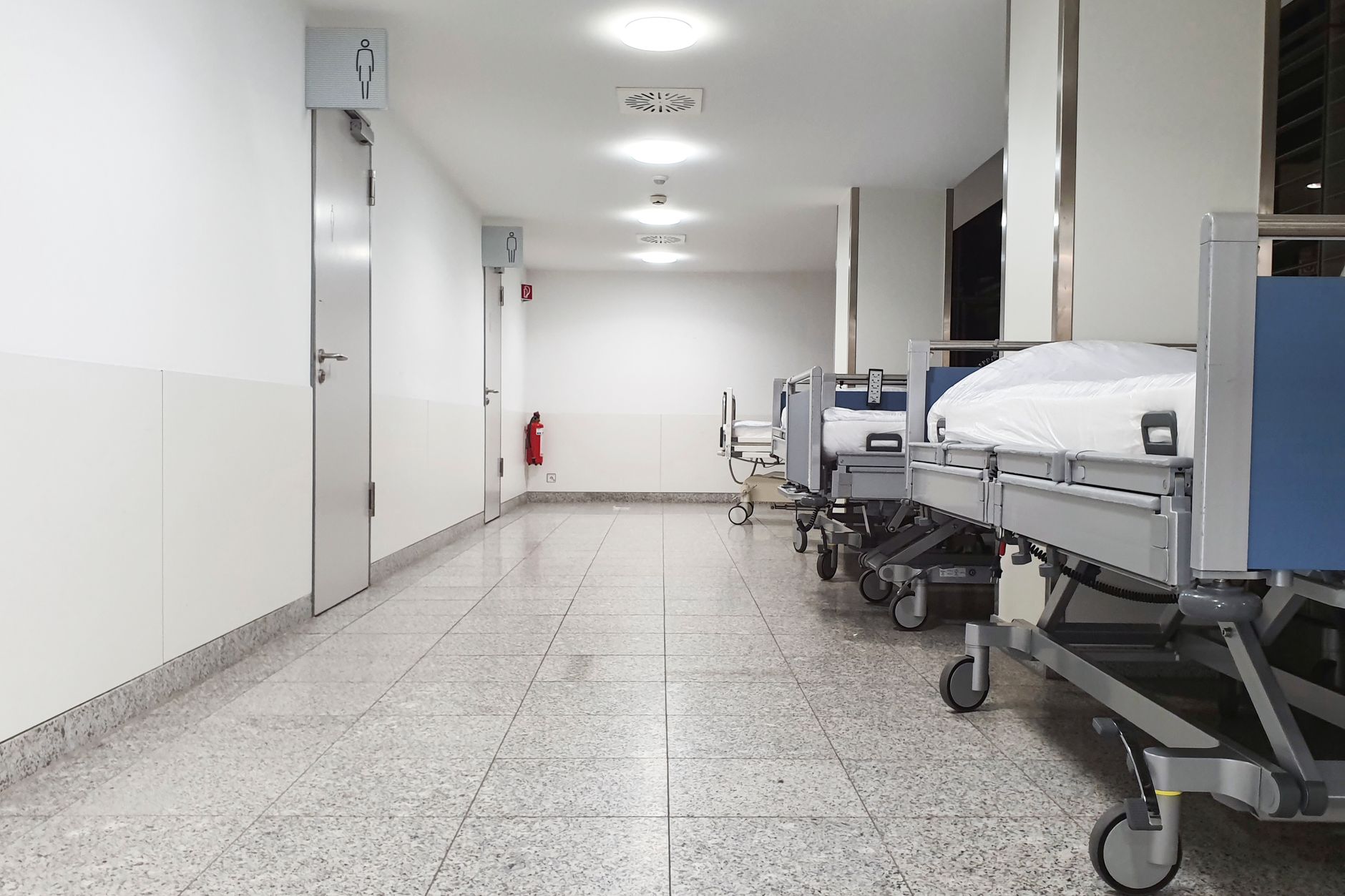 Hospital beds lined along a ward corridor, the kind of unit whose patient population decides which CCRN variant you are eligible for