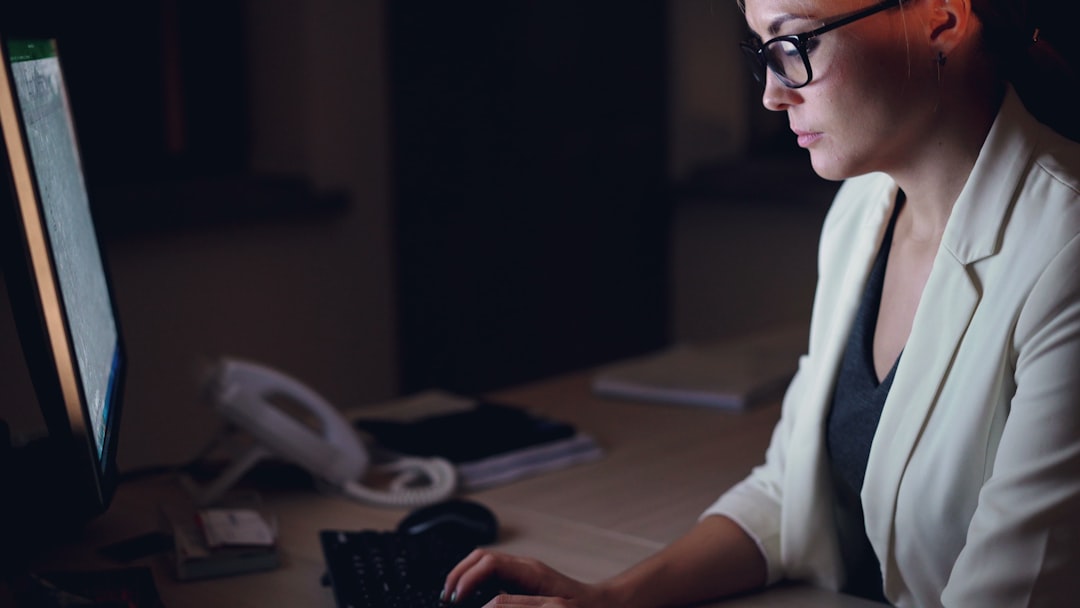 Nurse concentrating at a screen, working through the case-based clinical judgement scenarios the CCRN exam is built from