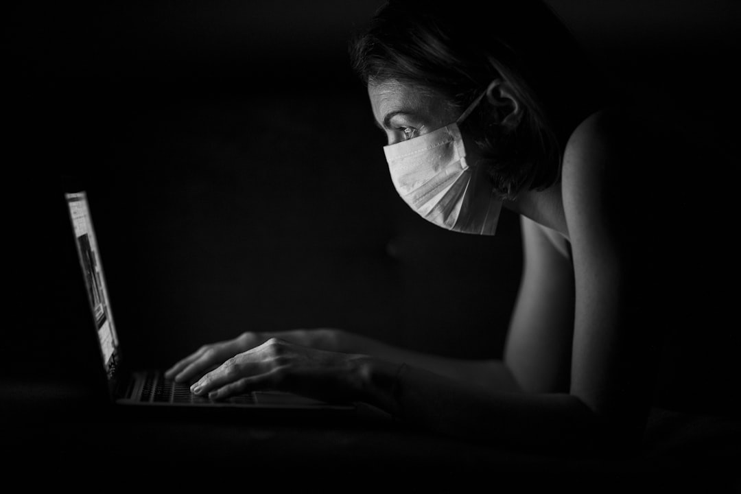 Critical care nurse studying CCRN practice questions on a laptop after a twelve-hour shift