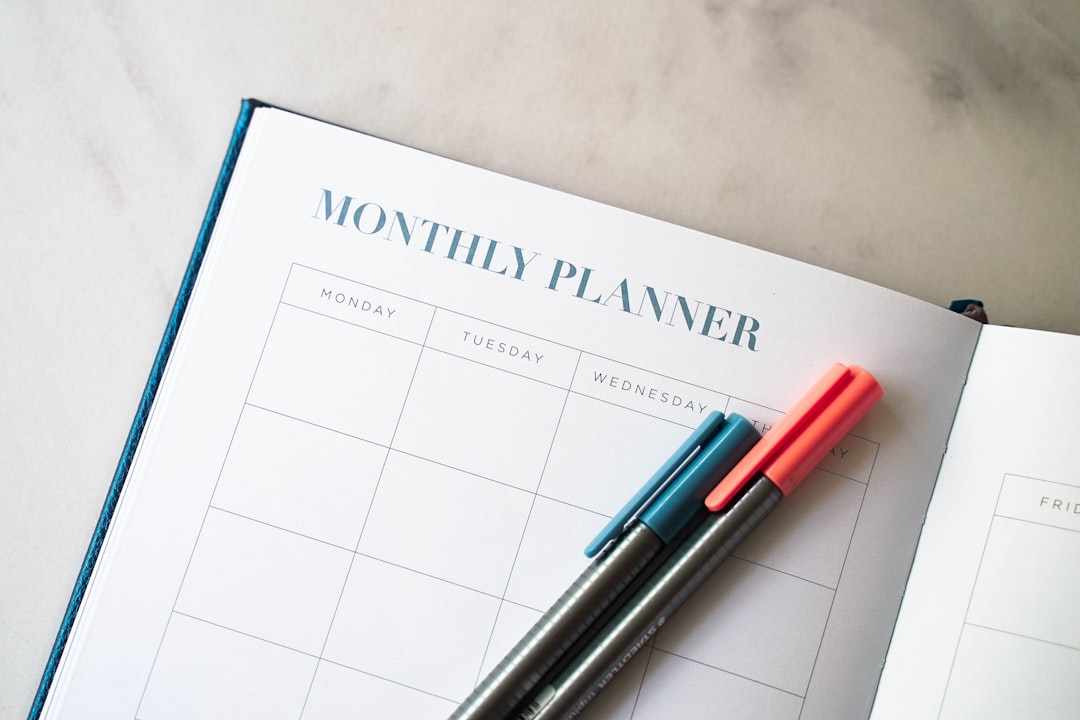 Blank monthly planner with pens, used to sequence a six-week CCRN study plan around shift work
