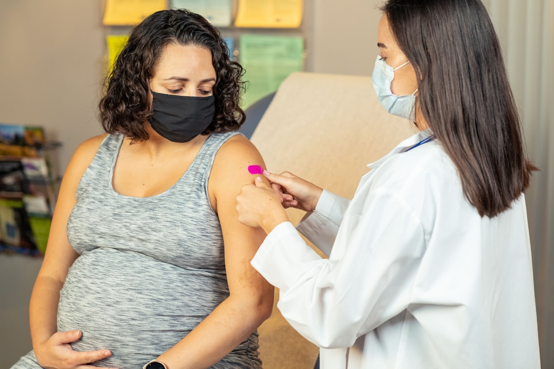 Certified nurse-midwife examining a pregnant patient during a routine prenatal appointment