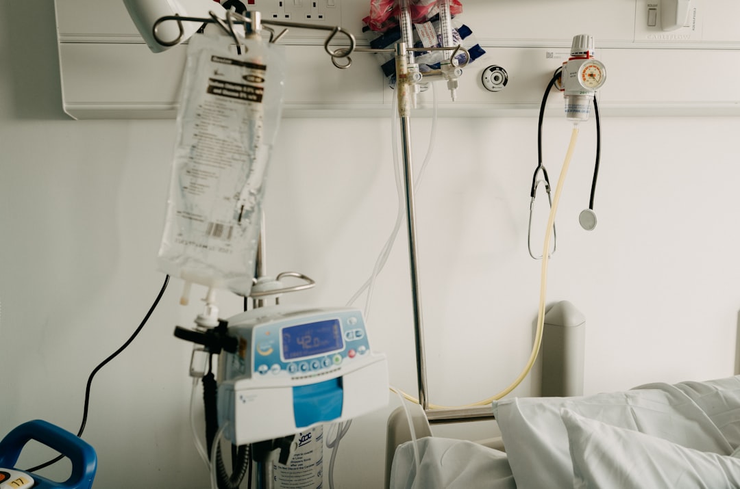 Infusion pump, IV bag and oxygen flowmeter at a hospital bedside, the medication administration and monitoring a CRNA manages through a procedure