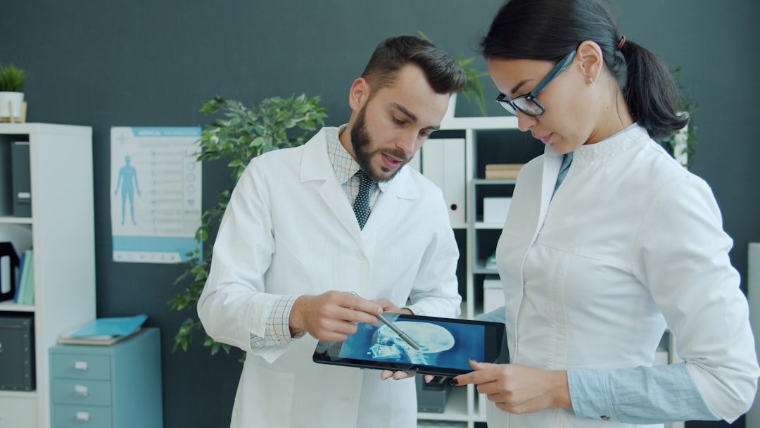Two healthcare leaders reviewing performance data, a route into nurse executive roles