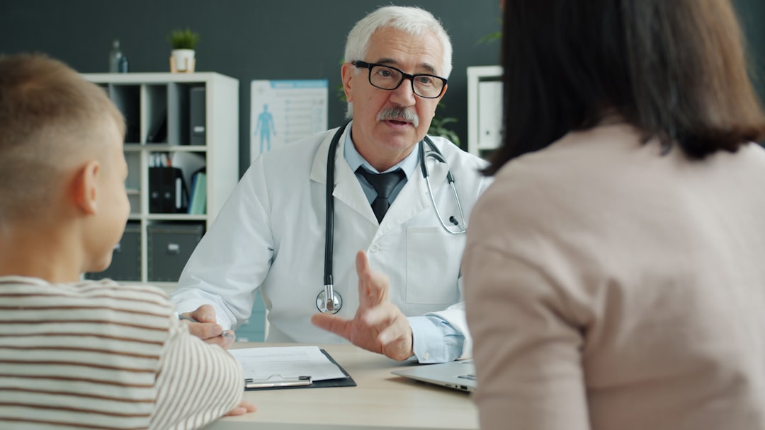 Nurse practitioner consulting with a mother and young child during a primary care visit