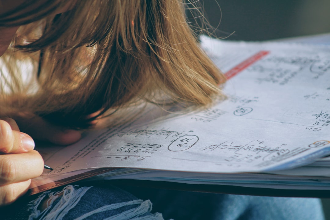 Student working through chemistry equations and unit conversions in a notebook