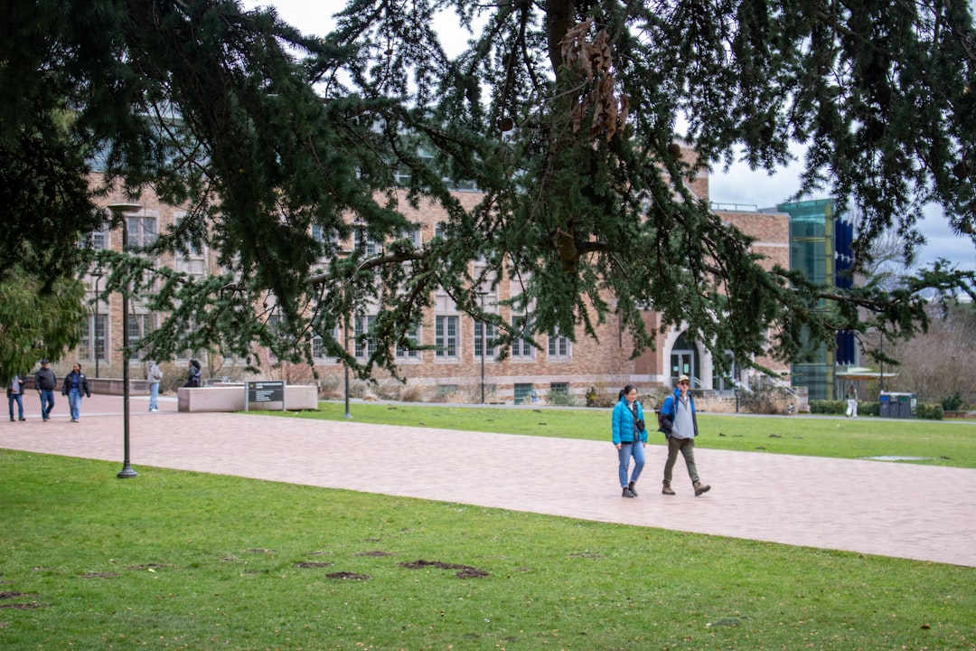 Nursing students walking across a college campus between prerequisite classes