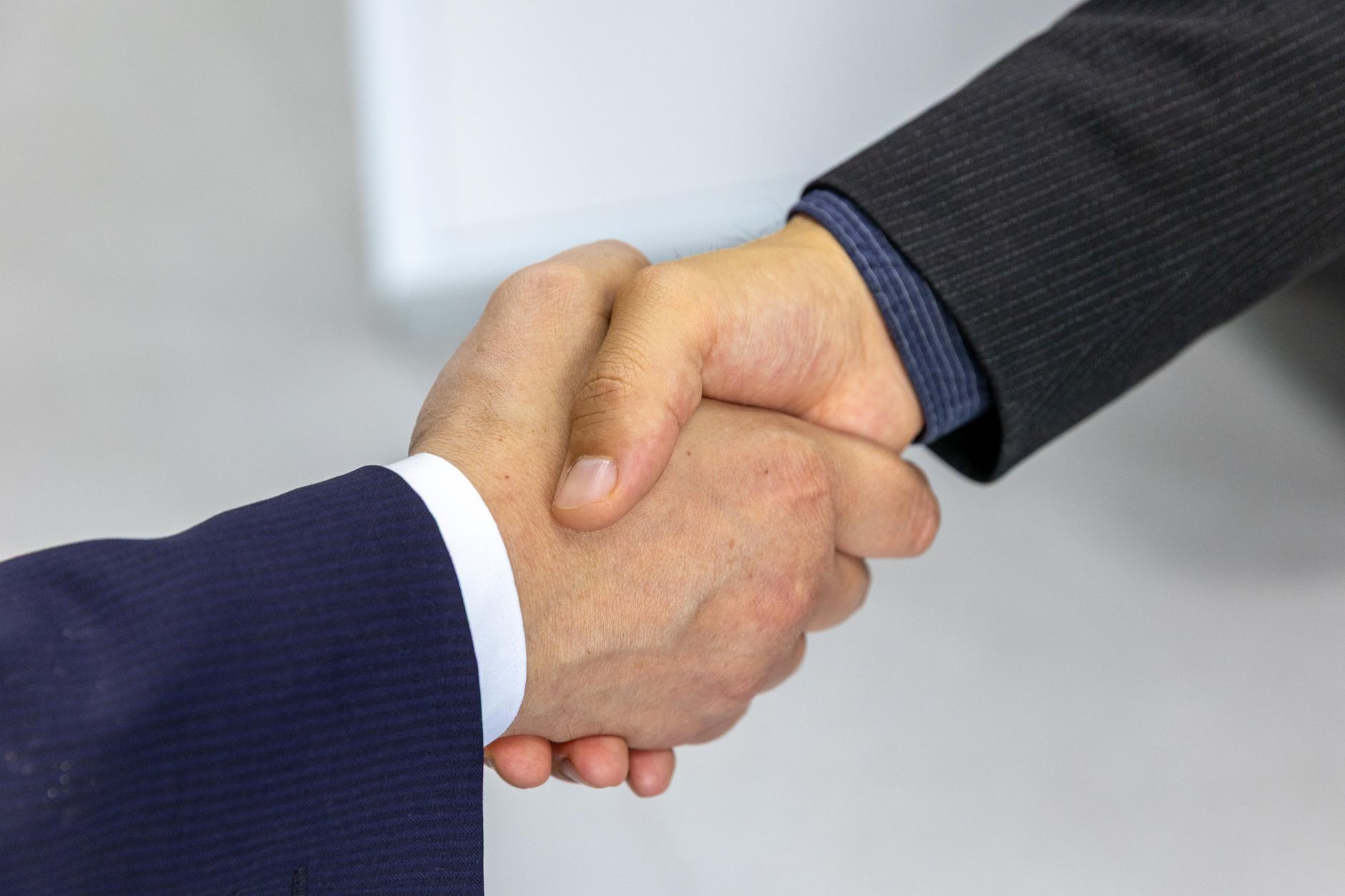 Handshake over a contract, representing the agency agreement a travel nurse signs