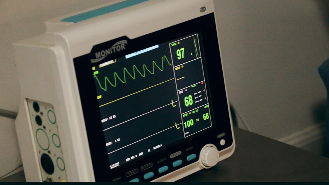 Bedside patient monitor displaying oxygen saturation, heart rate and blood pressure