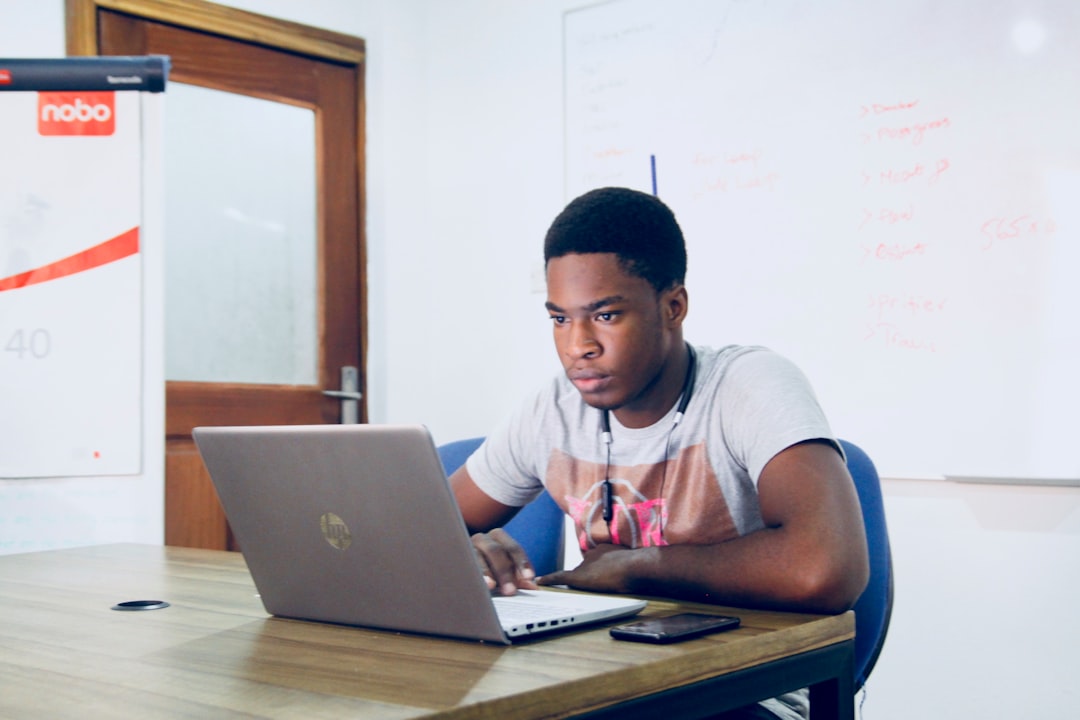 A pre-nursing student looking focused while taking a timed TEAS practice test on a laptop