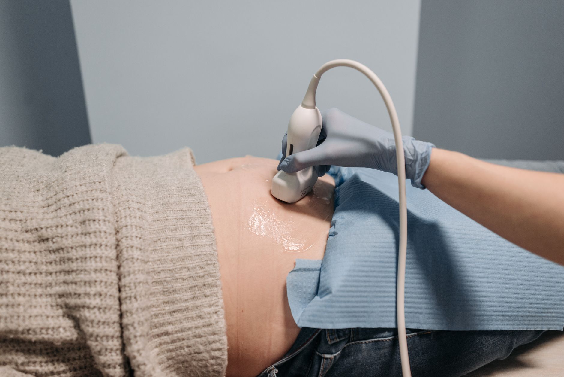 Clinician performing an obstetric ultrasound during a prenatal assessment