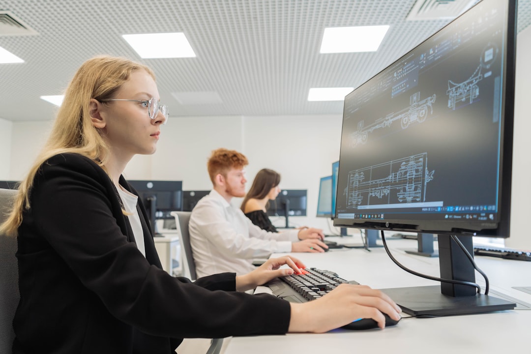 Candidates at computer workstations taking a computer-based adaptive exam