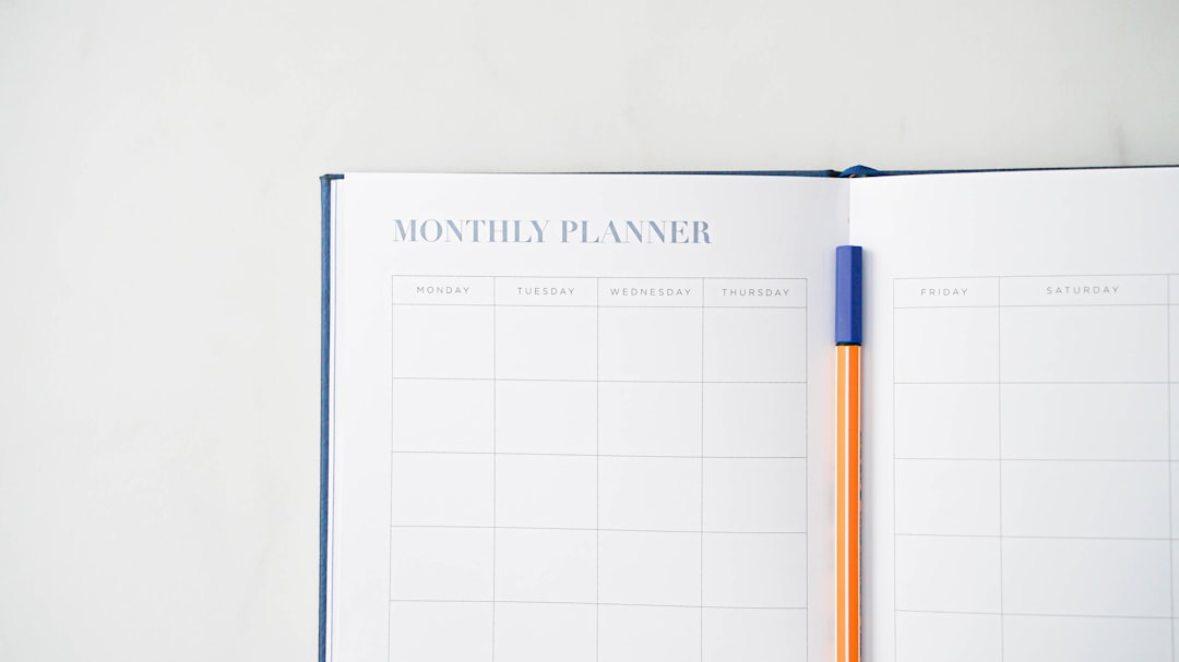 Open monthly planner with a pen, used to map NCLEX-RN study time to the test plan category weights