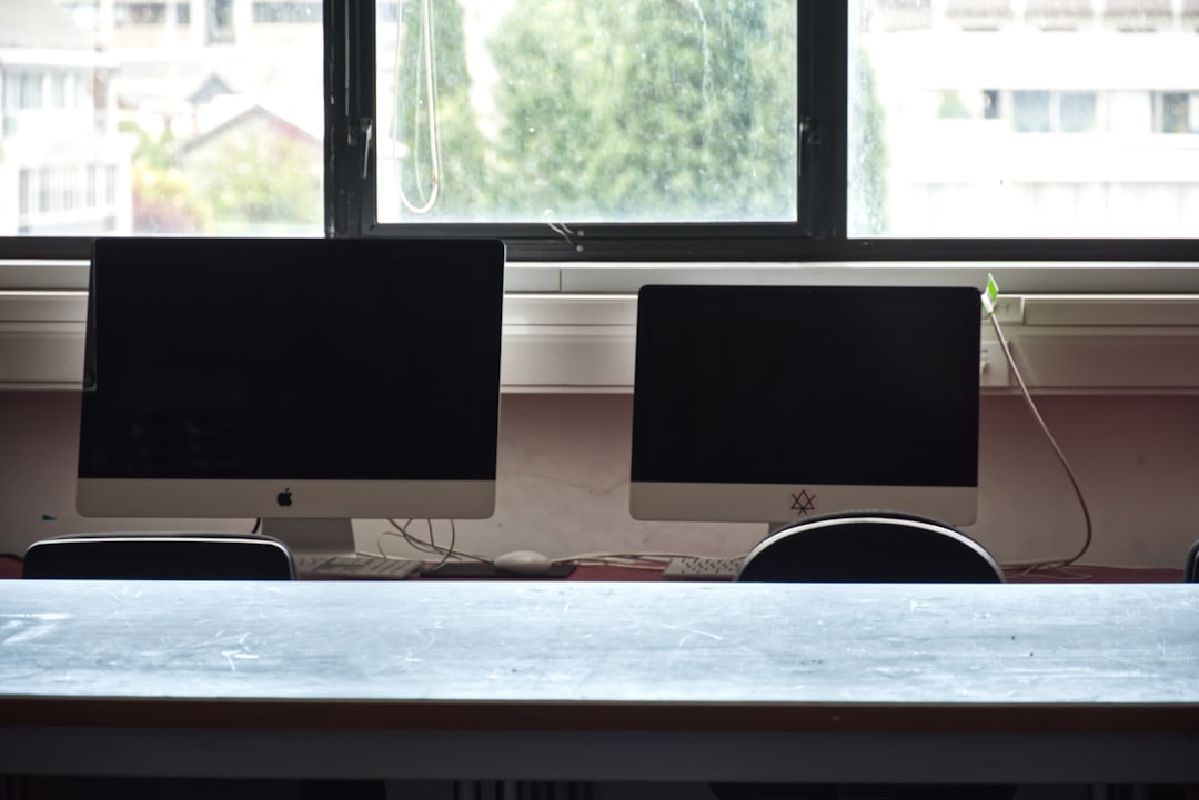 Computer workstations set up for individual candidates in a testing room