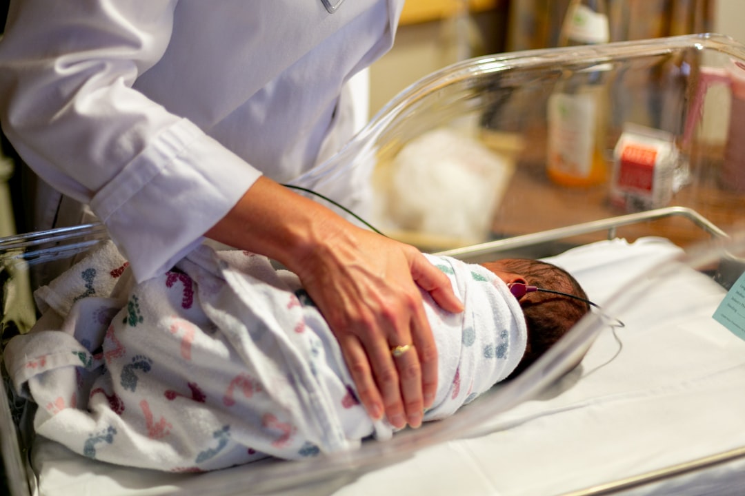Clinician assessing a newborn during a neonatal examination