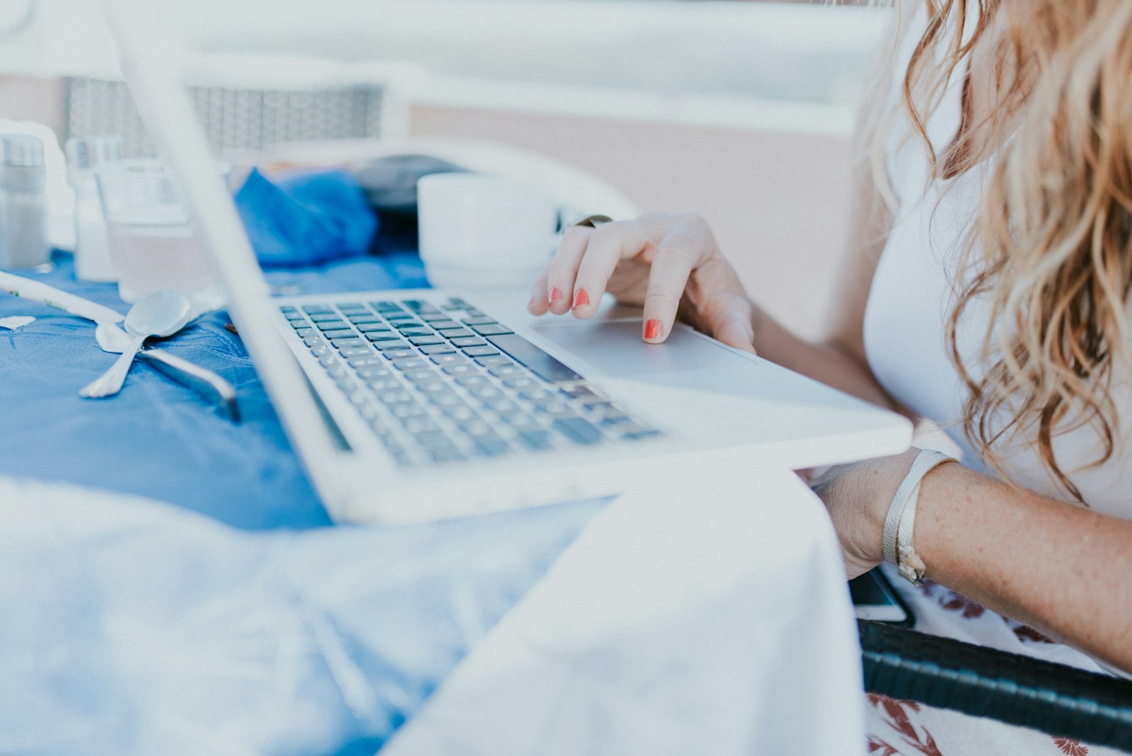 Prospective nurse practitioner researching programs on a laptop, before the population-focus decision that fixes what they can be licensed to treat