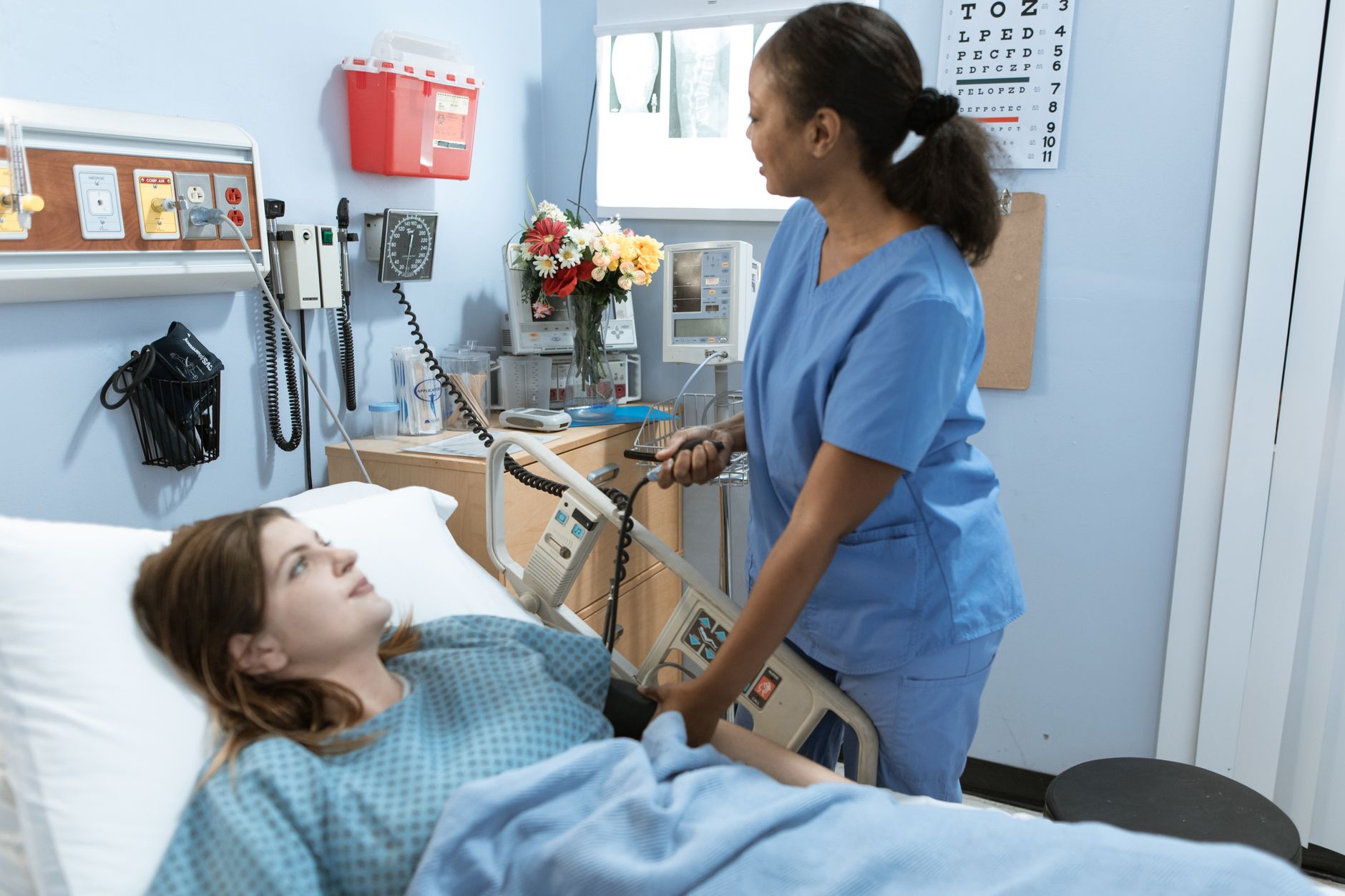 Nurse taking a patient's blood pressure during a supervised clinical placement