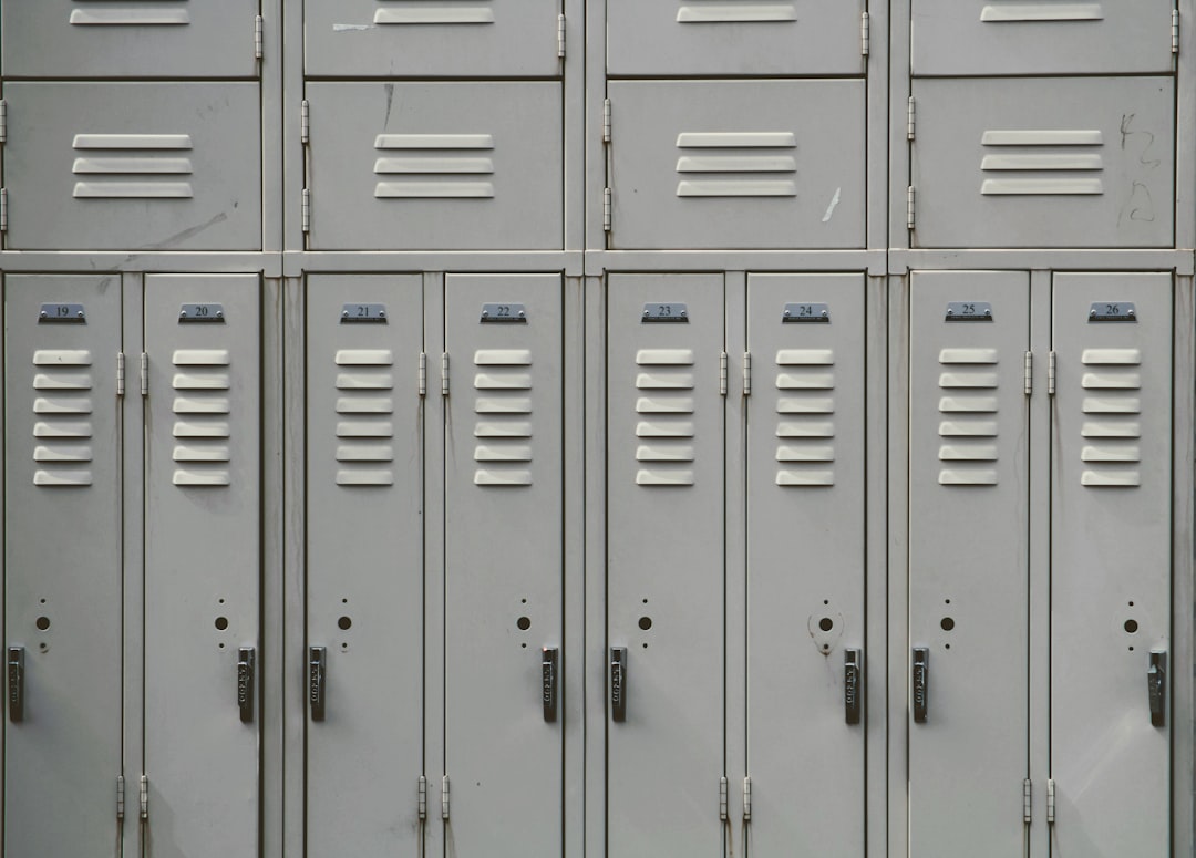 Empty school hallway lined with lockers, the setting for school nursing practice